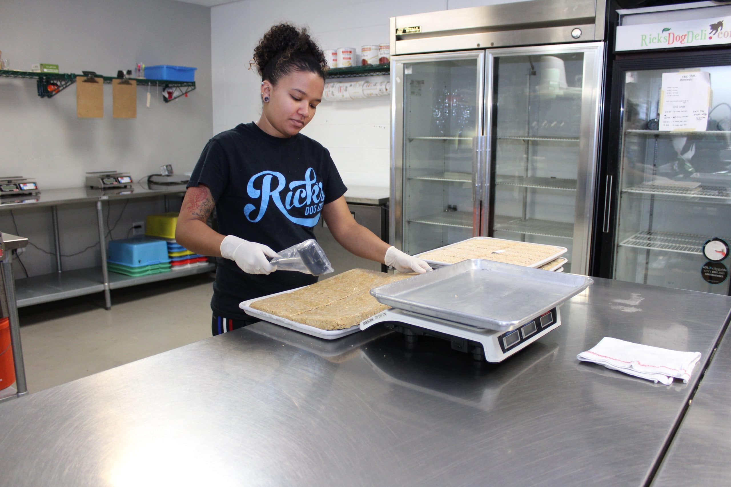 A Rick's Dog Deli employee making our fresh Orlando dog food in the kitchen.